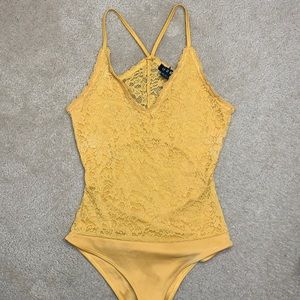 Yellow lace open back body suit